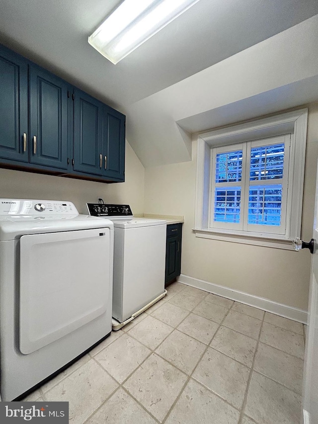 laundry room with cabinets and washing machine and clothes dryer