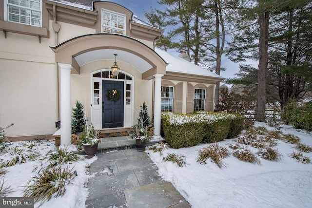 view of snow covered property entrance