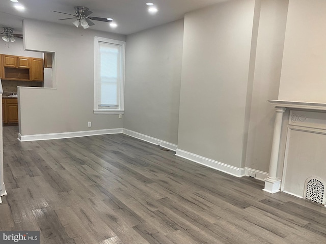 unfurnished living room featuring dark hardwood / wood-style floors and ceiling fan