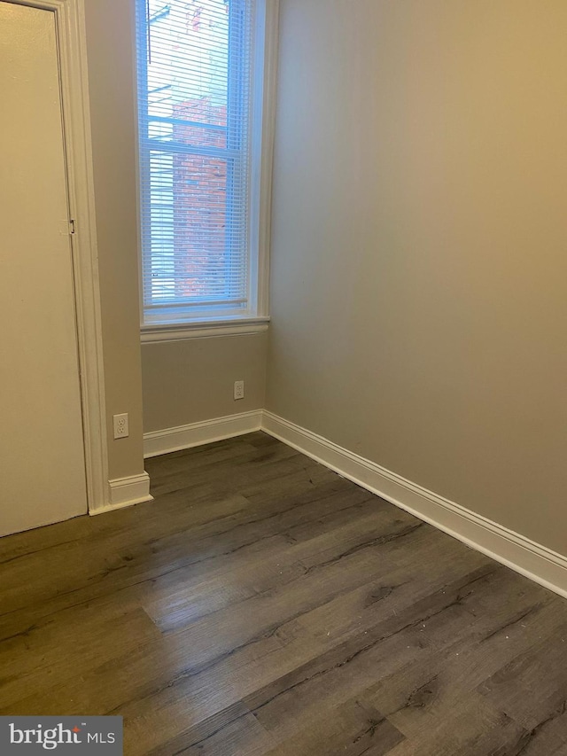 empty room featuring dark wood-type flooring