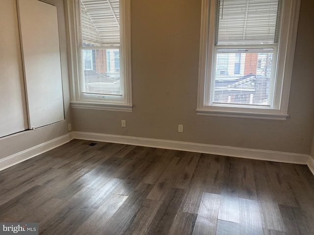 empty room featuring dark hardwood / wood-style flooring