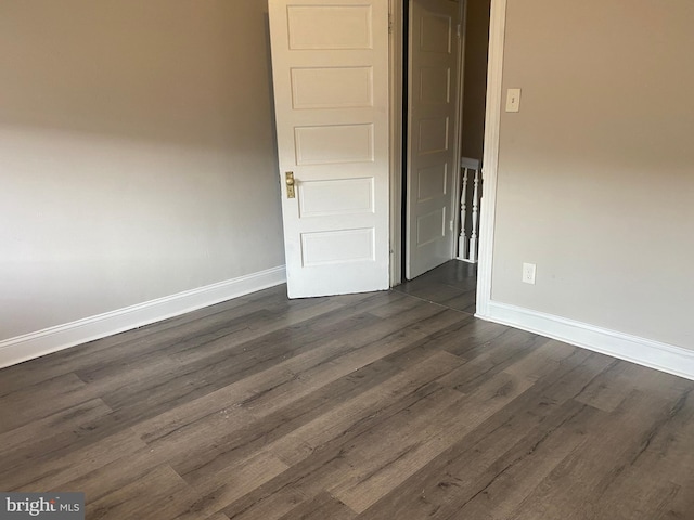 empty room featuring dark wood-type flooring