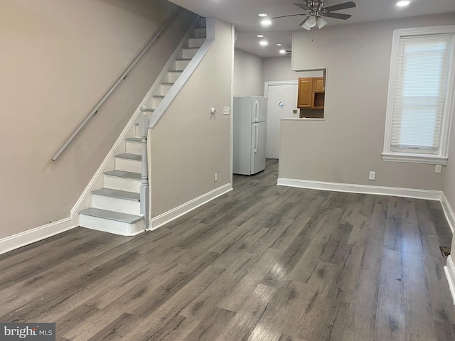 unfurnished living room with ceiling fan and dark hardwood / wood-style flooring