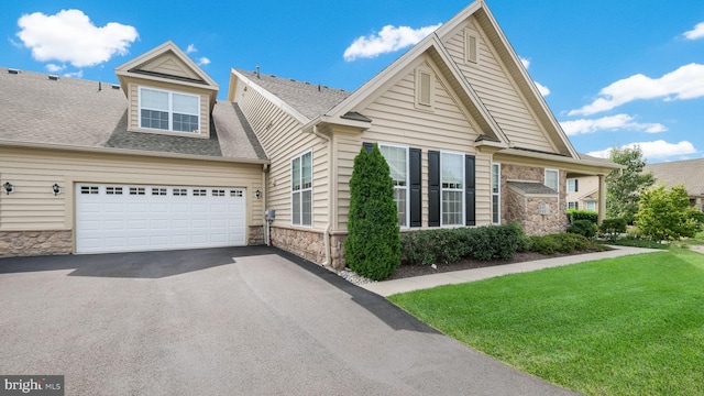 view of front of property with a front lawn and a garage