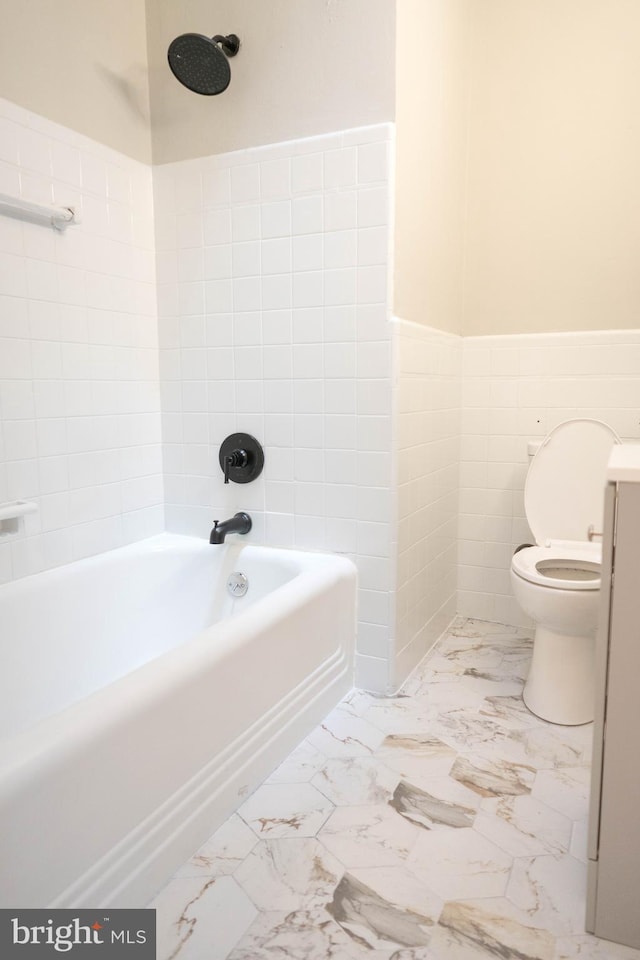 full bathroom with vanity, toilet, tile walls, and bathing tub / shower combination