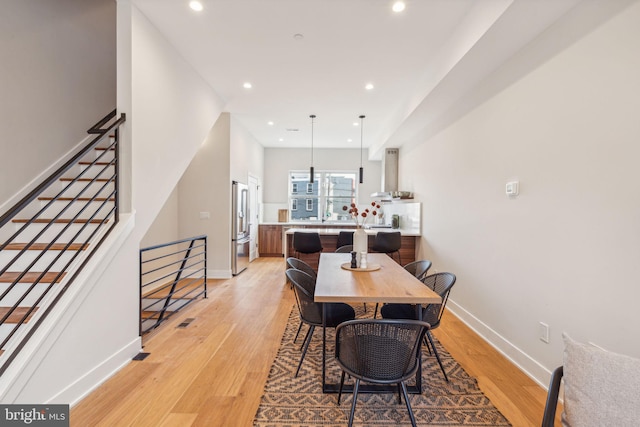 dining space with light hardwood / wood-style flooring