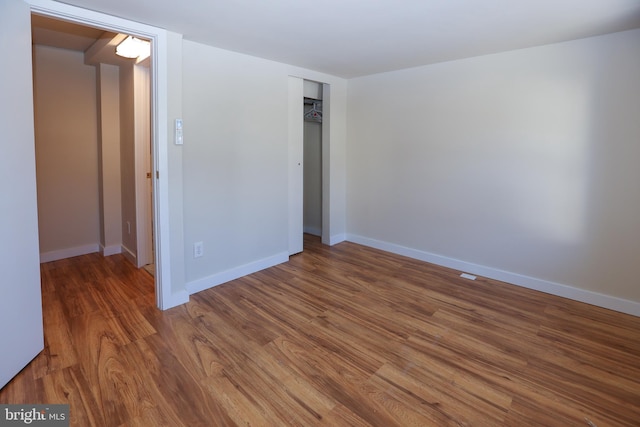 unfurnished room with hardwood / wood-style floors