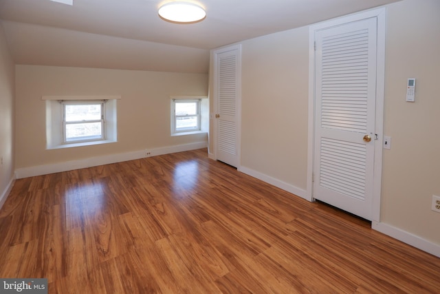 empty room featuring hardwood / wood-style floors and lofted ceiling