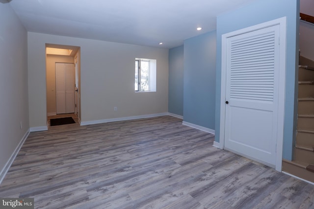 unfurnished bedroom featuring light wood-type flooring and a closet