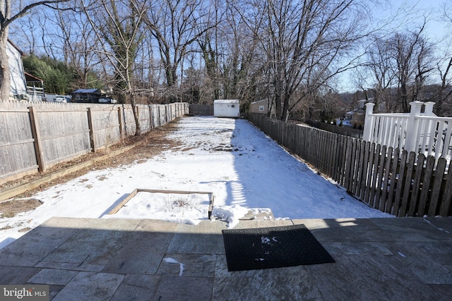 view of yard layered in snow