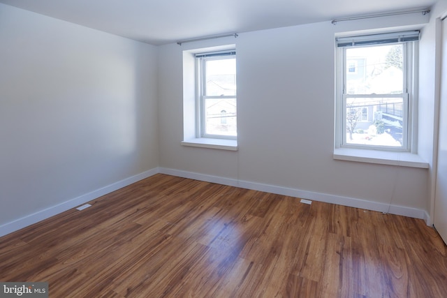 empty room with dark hardwood / wood-style floors