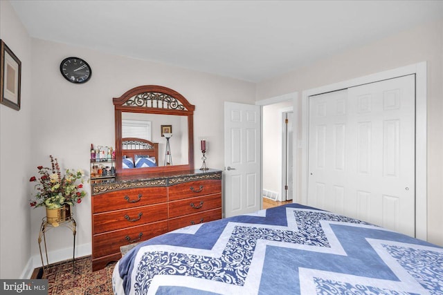 bedroom with hardwood / wood-style flooring and a closet