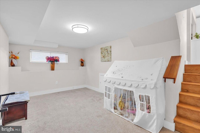 recreation room featuring light colored carpet