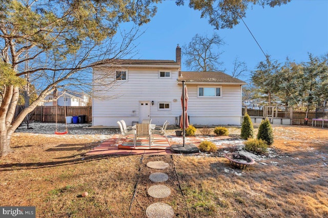 rear view of property featuring a patio area