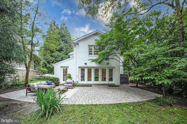 rear view of property featuring outdoor lounge area, a patio area, and french doors