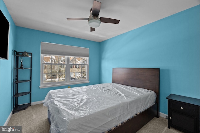 bedroom with ceiling fan and light carpet