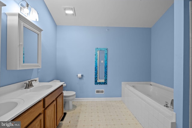 bathroom featuring vanity, toilet, and tiled tub