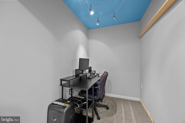 office space with carpet and track lighting