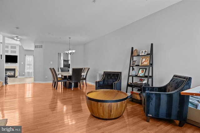 dining space featuring hardwood / wood-style flooring and a notable chandelier