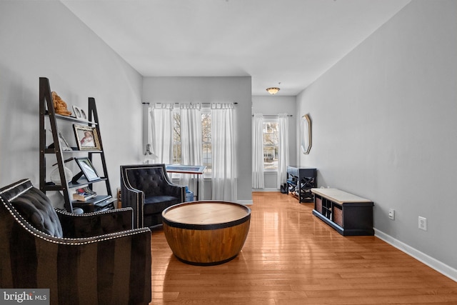 living area with hardwood / wood-style flooring