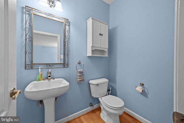 bathroom featuring toilet and wood-type flooring