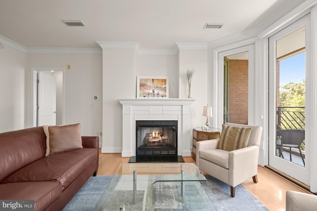 living room with light hardwood / wood-style floors and ornamental molding