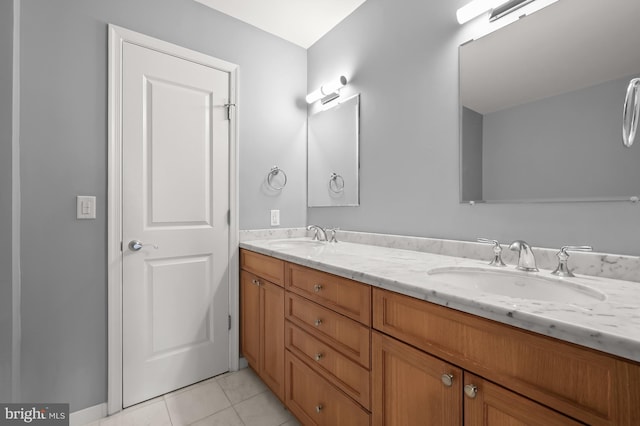 bathroom with tile patterned floors and vanity