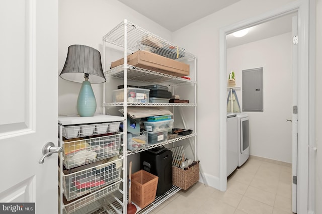 interior space featuring electric panel, light tile patterned floors, and washer and dryer