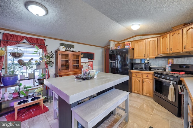 kitchen featuring tasteful backsplash, ornamental molding, vaulted ceiling, and black appliances