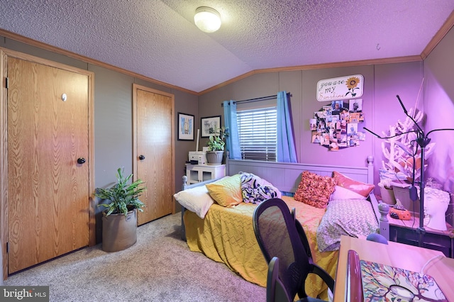 carpeted bedroom featuring ornamental molding, vaulted ceiling, and a textured ceiling