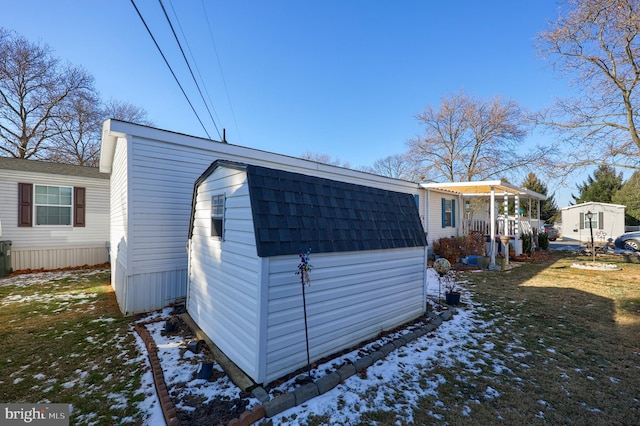 snow covered property with a lawn