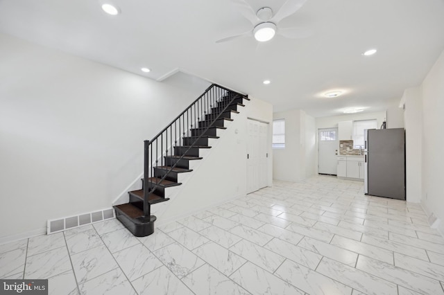 staircase with ceiling fan