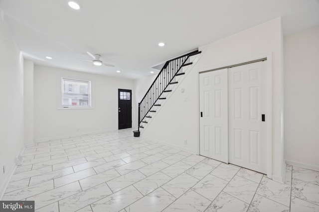 interior space with ceiling fan