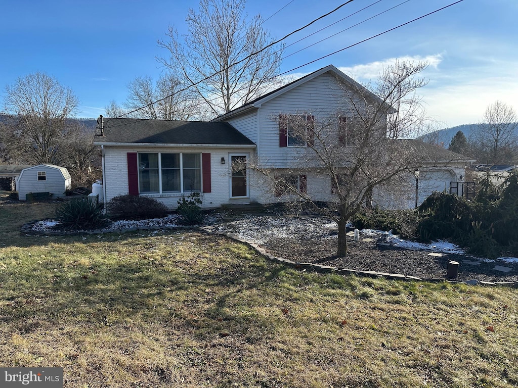 split level home featuring a front lawn