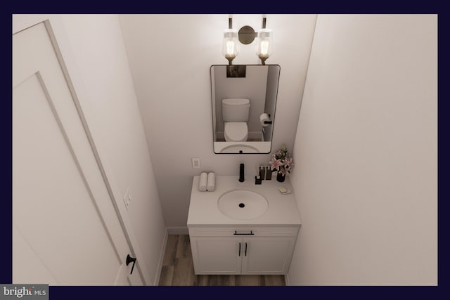 bathroom featuring toilet, hardwood / wood-style floors, and vanity