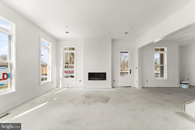 10634 Pocket Pl, Fairfax, VA 22030 - unfurnished living room with a glass covered fireplace, visible vents, and unfinished concrete floors