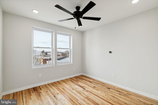 unfurnished room with hardwood / wood-style flooring and ceiling fan