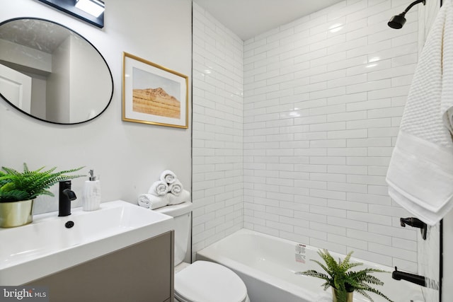 full bathroom featuring vanity, toilet, and tiled shower / bath