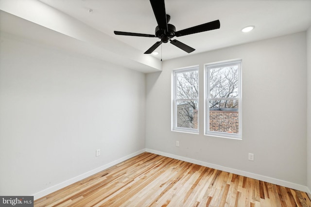 empty room featuring ceiling fan and light hardwood / wood-style flooring