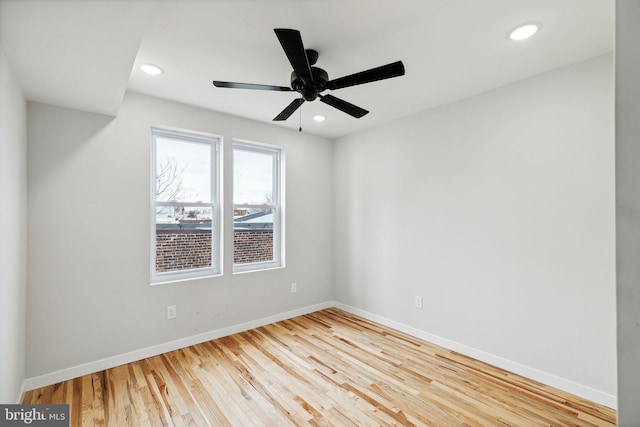 empty room with ceiling fan and wood-type flooring