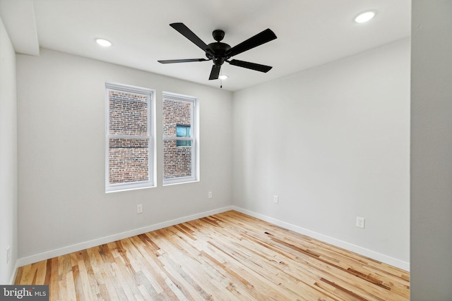 empty room with hardwood / wood-style floors and ceiling fan