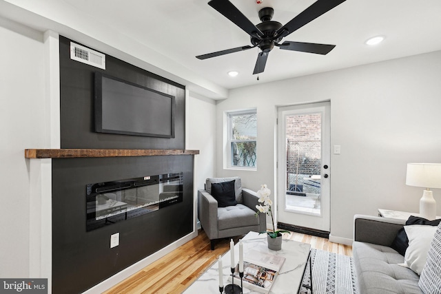 living room with hardwood / wood-style floors and ceiling fan