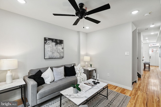 living room with ceiling fan and light hardwood / wood-style floors