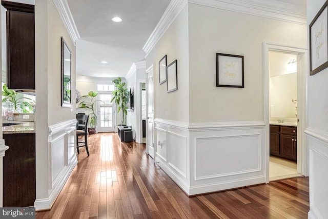 corridor with crown molding and hardwood / wood-style floors