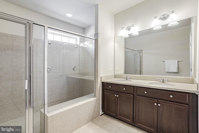 bathroom with tile patterned floors, vanity, and a shower with shower door