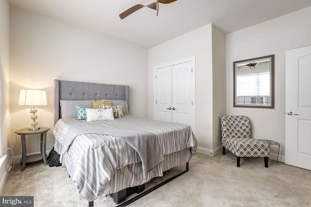 bedroom featuring light carpet, a closet, and ceiling fan