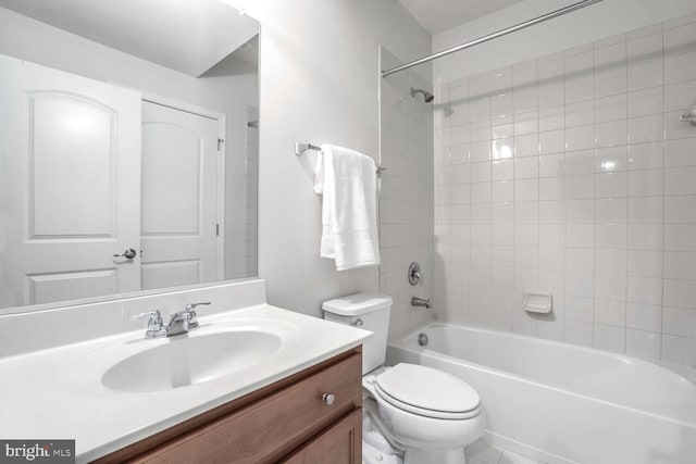 full bathroom featuring vanity, toilet, and tiled shower / bath