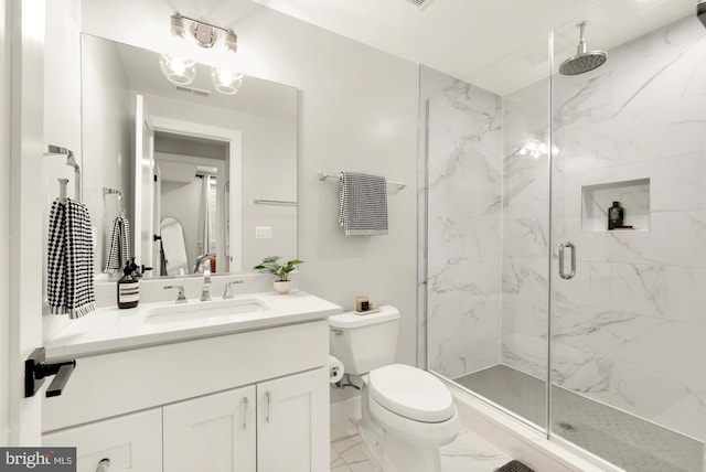 bathroom with vanity, toilet, and an enclosed shower