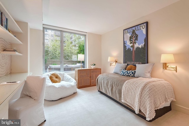 carpeted bedroom featuring expansive windows