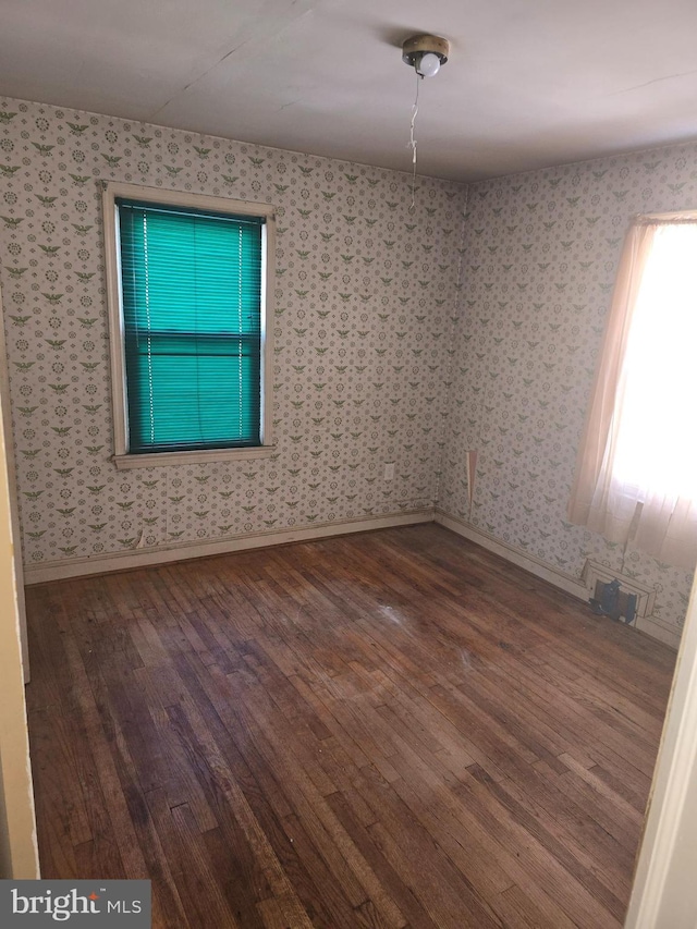 empty room with hardwood / wood-style flooring